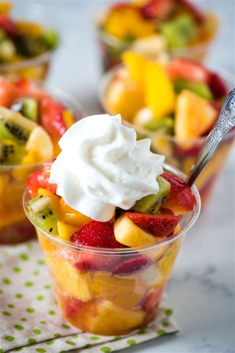 Preparing a fruit cup at home with various fruits and a lime